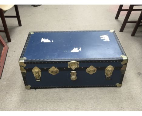A blue travelling trunk bound by brass with a detachable storage divider. Manufactured by Massman of London.