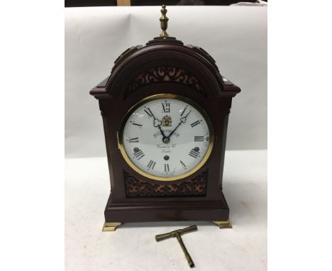 A Garrard & Co. arch top mantelclock having Roman numerals on a white enamel dial. Height approx 39cm