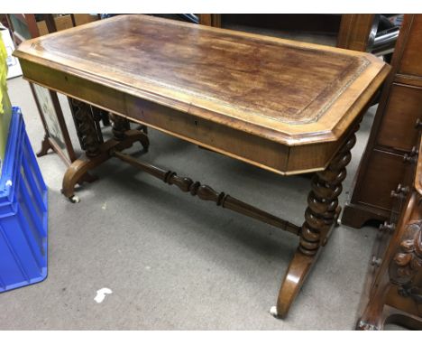 A Victorian walnut desk with inset leather octagonal top raised on barley twist legs, approx 114cm x 62cm x 71cm.