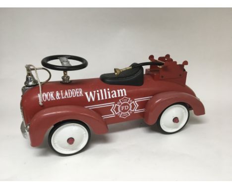 A child’s ride on fire engine, a quantity of old car rear lamps, a petrol can and an oil bottle.