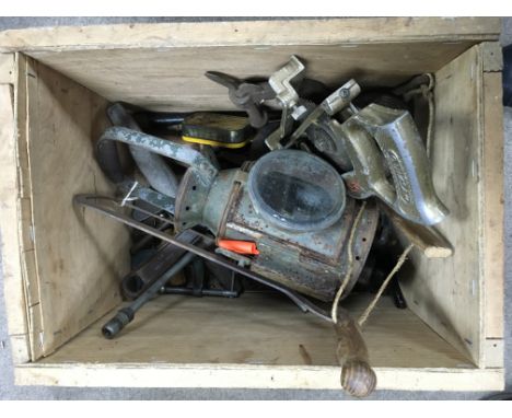 A small wooden crate of old tools and a lamb