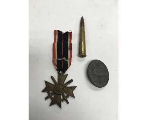 A WW2 German lapel badge, German 1939 Star and a bullet marked 1943.