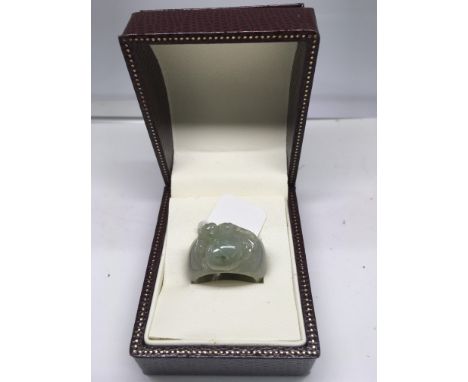 An unusual jade ring carved with a bat eating a peach, boxed