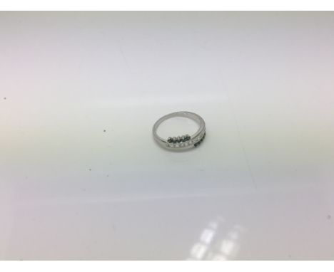 A 9ct whitengood ring with blue and white diamonds. Ring size M.