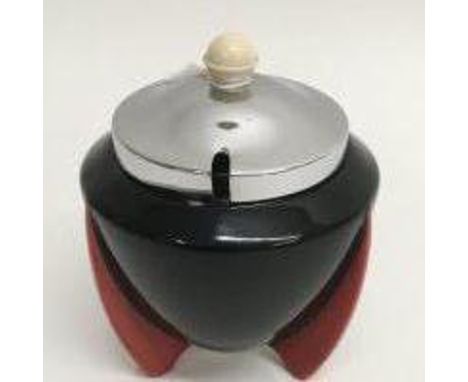 An Art Deco Wilkinson 'Yoo Hoo' pattern sugar pot having black body on red fin shaped feet with chrome lid and handle, design