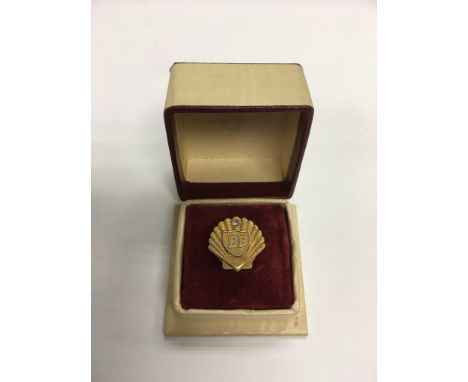 A 9ct gold BP pin badge for long service.