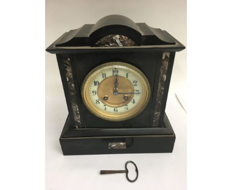 An eight day slate mantle clock