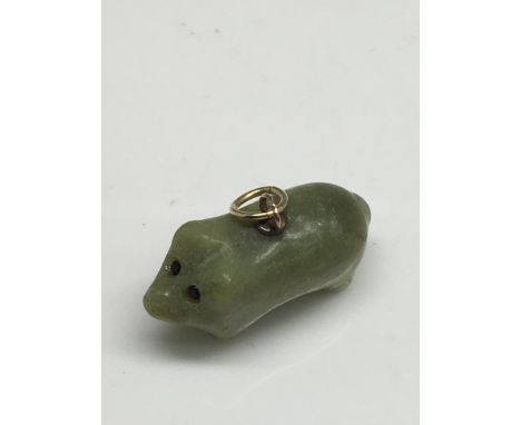 A jade pig pendant with gold loop.Approx 1.5cm long