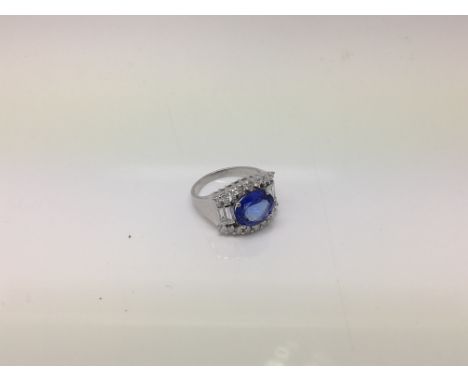 A 14ct white gold diamond and tanzanite ring. Ring size P. Tanzanite is 3.9 carat with a 1.2 Carat diamond.