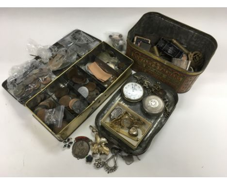 A tin of odds including a silver cased pocket watch, military tunic buttons, costume jewellery items plus a tin of old coins 