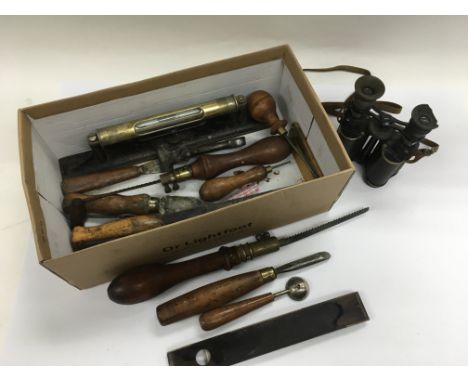 A box of odds including a pair of binoculars, vintage tools etc.