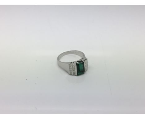 A 14ct white gold emerald and diamond ring. Ring size P.