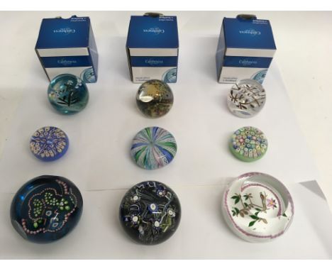 A collection of nine paperweights including a Whitefriars 1982 limited edition facet cut weight, two John Deacon weights and 