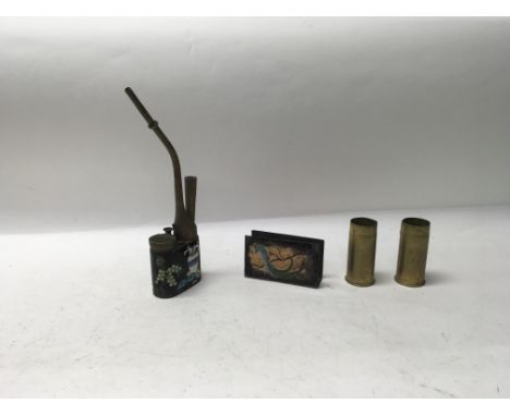 A Chinese enamelled opium pipe with an enamelled copper box holder and two brass shell cases.