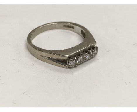 An 18ct white gold ring set with four diamonds, approx 4.6g and approx size N-O.