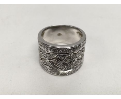 An 18ct white gold set with diamonds and having pierce work decoration, approx 12g and approx size M-N.