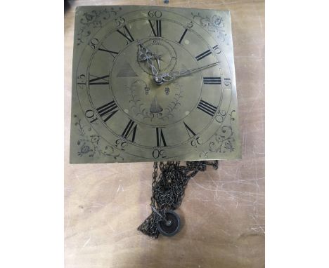 A longcase brass clock face with Roman numeral dial