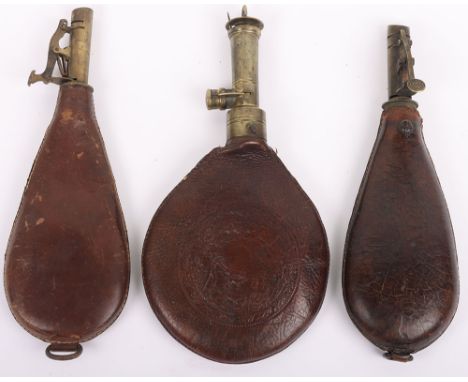 Antique Vintage Shot Flasks: Three brass and leather body shot flasks, one with embossed decoration, two with shot inside. 3 