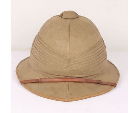 British Army Wolseley Pith Helmet: Vintage London made cork sun helmet complete with brown leather chin strap , some damage t