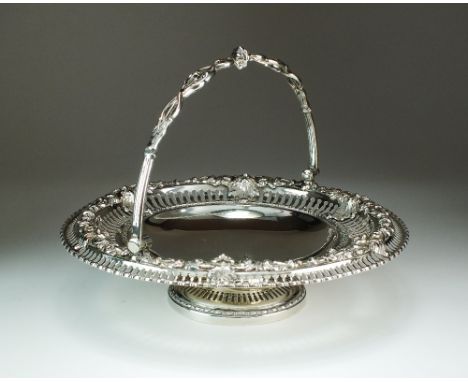 A Victorian silver swing handled cake basket, Henry Wilkinson & Co, London 1855, of circular pedestal form with pierced rim a