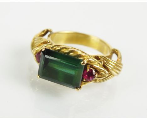 A three stone tourmaline and ruby dress ring, designed as a central rectangular cut green tourmaline flanked to each side by 