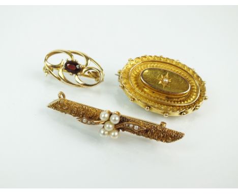 A seed pearl set bar brooch, the reverse with '15ct' plaque, together with a 15ct gold Victorian mourning brooch and a garnet