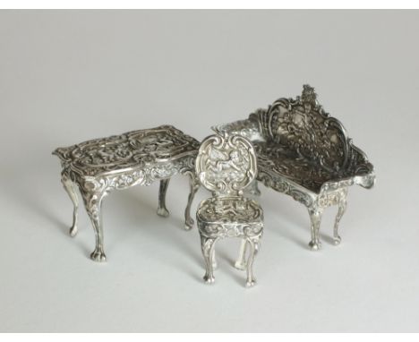 A suite of miniature silver furniture, Da-mar Silverware, Birmingham 1975/76, comprising; a sofa, table and chair, each with 