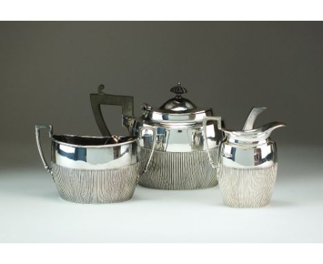 An Edwardian Bachelors three piece silver tea service, James Dixon & Sons Ltd, Sheffield 1901, each piece of oval half reeded