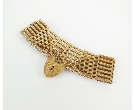 A 9ct gold seven bar gate link bracelet, with heart shaped padlock clasp, weight 24.4g