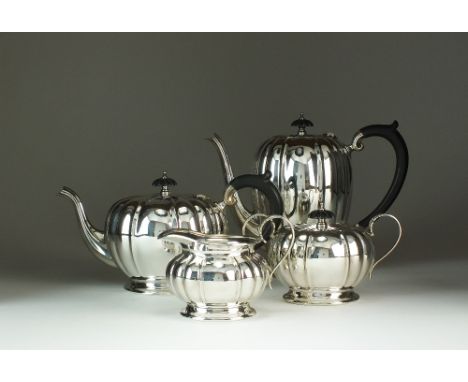 A four piece silver tea and coffee service, Barker Brother Silver Ltd, Birmingham 1937, each piece of melon form, comprising;