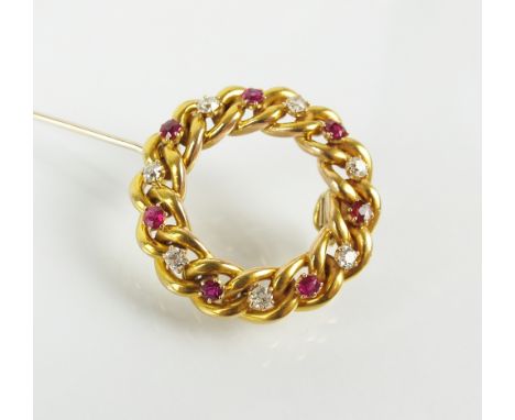 A ruby and diamond wreath brooch, designed as fourteen alternating round cut rubies and diamonds set to circular openwork yel