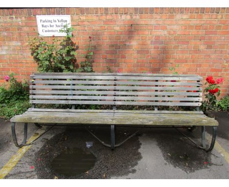 An iron framed and oak slatted garden bench, 34"h x 96" x 27" 