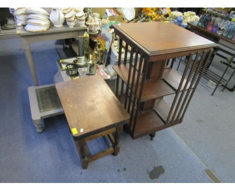 An Edwardian mahogany revolving bookcase, together with a reproduction lamp table with a single drawer 