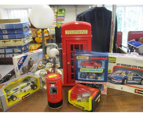 A retro Snoopy table lamp together with diecast vehicles, mixed toys and a telephone housed in a red phone box case 