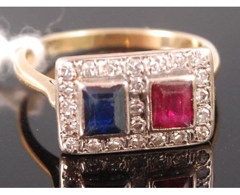 An Art Deco yellow metal (tests as 18ct), ruby, sapphire and diamond ring, arranged as twin illusion set square cut ruby and 