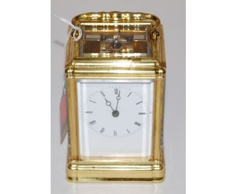 An early 20th century lacquered brass cased carriage clock, having enamelled dial with Roman numerals, and visible platform l