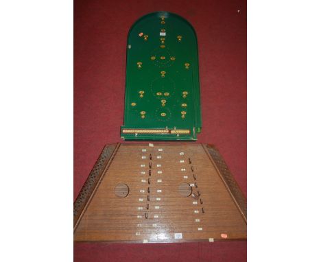 A mid-20th century green painted bagatelle board; together with a wooden zither (2)