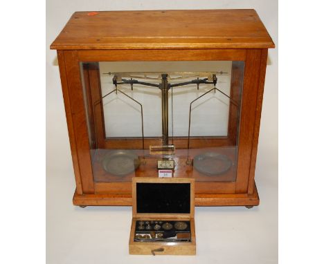 A mid-20th century set of chemists laboratory scales, in fitted teak case bearing label for A Gallenkamp & Co Ltd of London, 