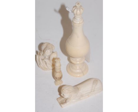 A 19th century turned ivory scent bottle; together with a carved ivory figure of a sphinx and a carved ivory figure of a bird