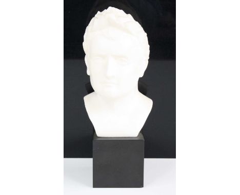 A faux marble head and shoulders portrait bust of Emperor Ceasar, impressed verso A6 Modele Depose, raised on a black slate p