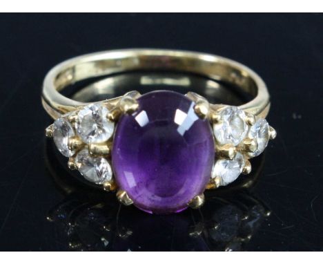 An 18ct yellow gold, amethyst and diamond ring, the oval amethyst estimated as weighing 2.78 carats, with a trefoil of diamon