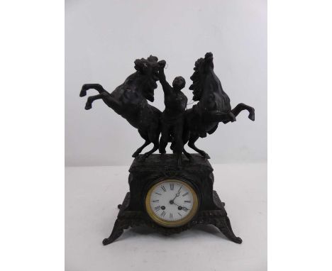 A 19th century spelter eight day mantel clock, the case mounted with the Marly horses, the enamel dial showing Roman numerals