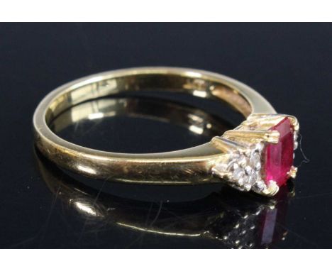 An 18ct yellow and white gold, ruby and diamond dress ring, having a rectangular ruby estimated as weighing 0.55 carats, and 
