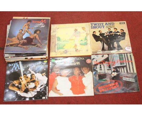 A collection of vintage 12" vinyl records, to include Elton john - Goodbye Yellow Brick Road, Boney M - Love For Sale, and Tw
