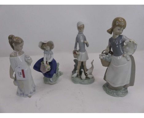 A Lladro porcelain figure of a girl, modelled standing holding a lamb, h.24cm; together with two other Lladro figures; and a 