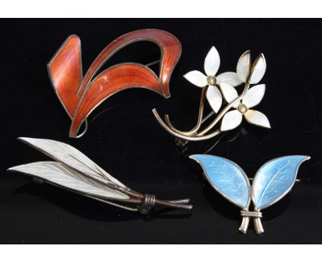 Four assorted enamel brooches, comprising a double blue leaf signed David Andersen; a white enamel stylised bouquet of flower