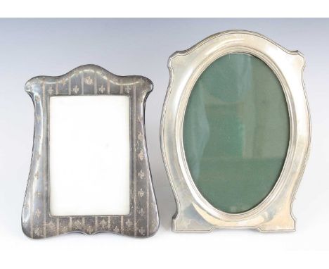 A George V silver clad easel photograph frame, of shaped rectangular form, with fluer de lys and engine turned decoration, Wa