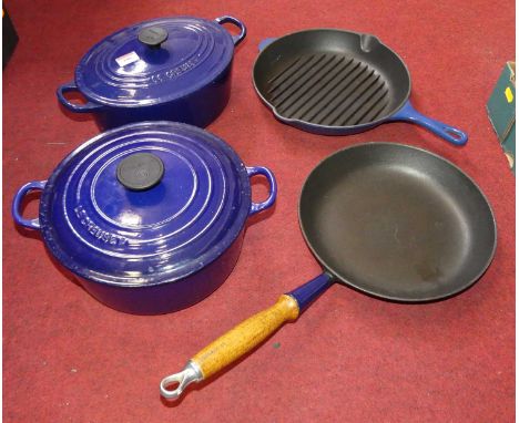 A collection of Le Creuset blue enamel cookwaresHeavily used but not damaged.