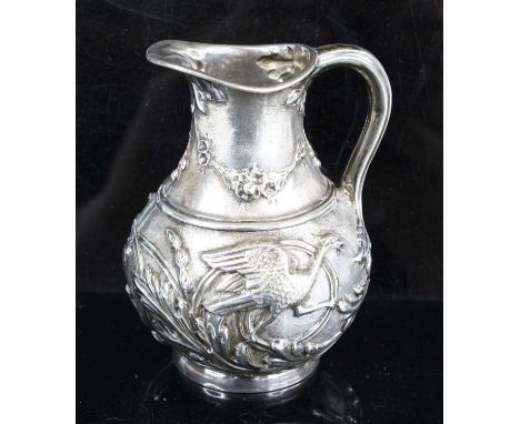 A Victorian silver jug, of squat baluster form, the body reposse decorated with birds and acanthus leaves, maker Henry Wilkin