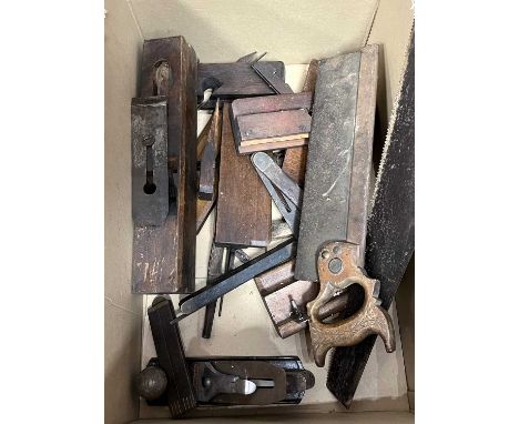 A collection of vintage woodworking tools, to include planes, saws, and levels 